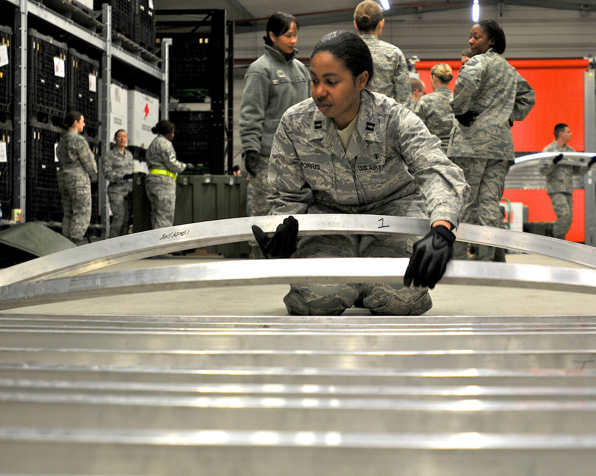 Capt. Paulencia Morris, 86th Dental Squadron, lays out parts of an expeditionary medical support tent in the medical logistics warehouse here Mar.3.  Members of the 86th Medical Group practiced assembling the EMEDS tent in preparation of their participation in an upcoming international mass casualty medical exercise held in the Netherlands.  (U.S. Air Force photo by Tech. Sgt. Markus M. Maier)