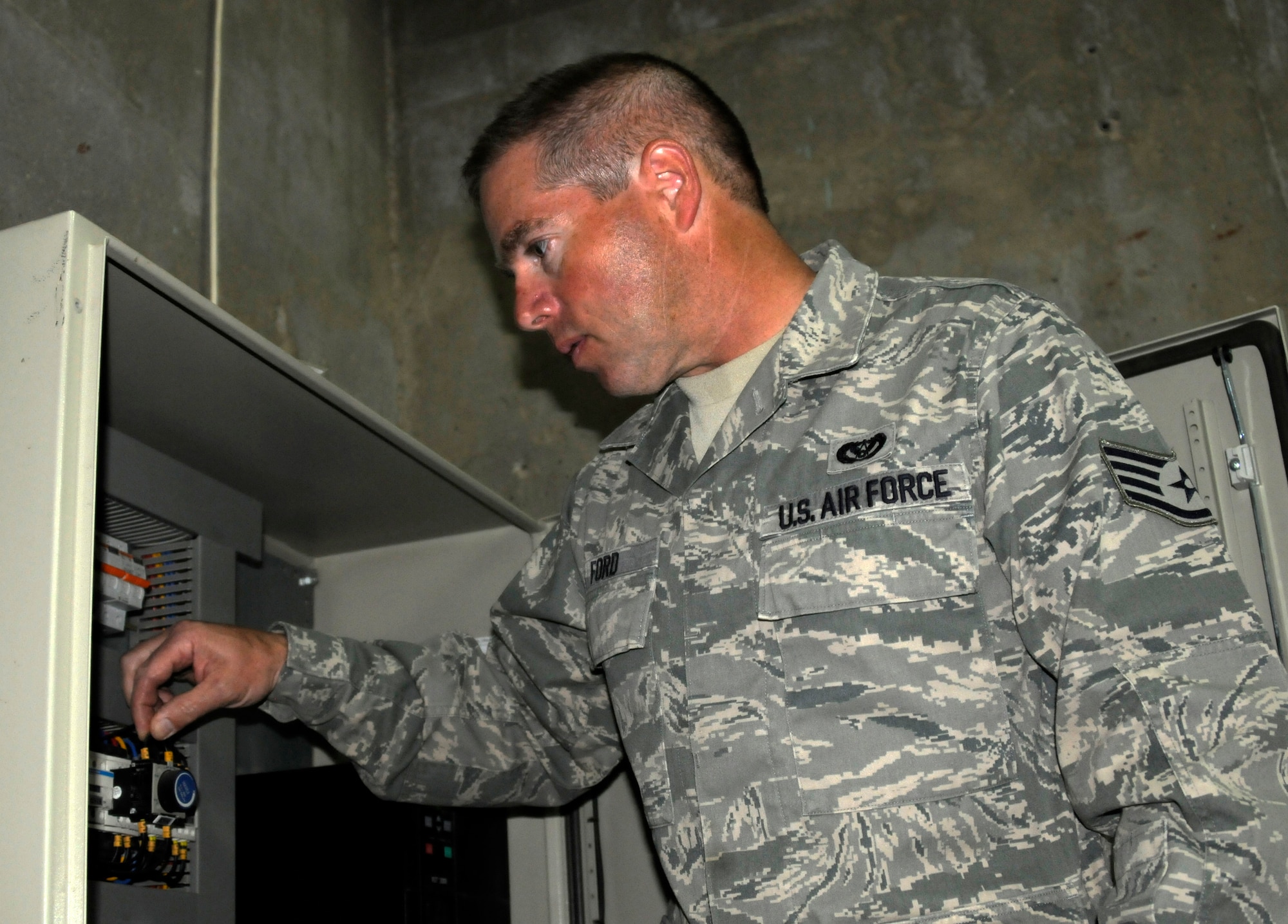 Staff Sgt. Tyler Ford conducts routing tests on a base water pump system March 3 at the 386th Air Expeditionary Wing. Sergeant Ford, now a member of the Kansas Air National Guard currently deployed with the 386th Expeditionary Civil Engineer Squadron, served in Operation Desert Storm in the U.S. Navy as an aviation electrician. (U.S. Air Force photo by Capt. Heath Allen)