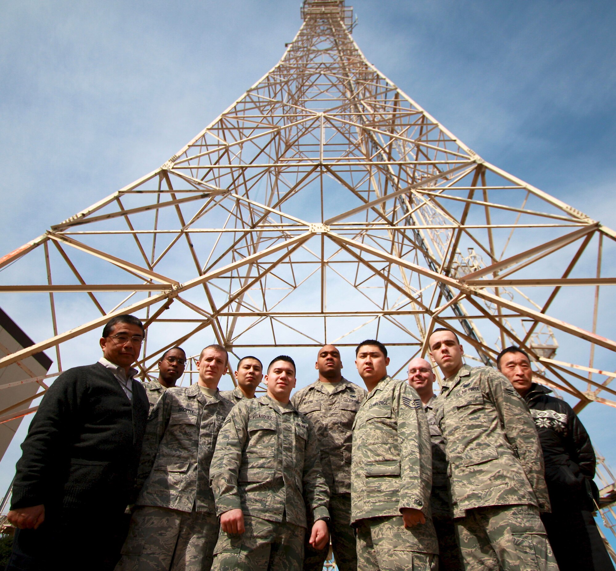 YOKOTA AIR BASE, Japan -- 2010 Pacific Area Defense Information Systems Agency (DISA) Outstanding Facility of the Year Award winners and a 2010 Pacific Air Forces Information Dominance Award winner stand beneath a communication tower. (Courtesy Photo) 