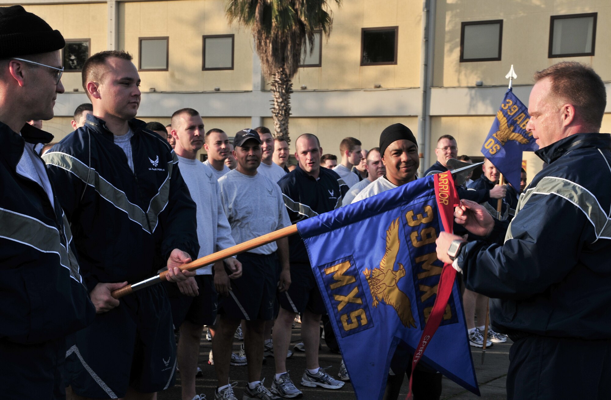 Col. Eric Beene, the 39th Air Base Wing commander, awards the spirit streamer to the 39th Maintenance Group after the wing run Feb. 24, 2011 at Incirlik Air Base, Turkey. The run was intended to boost morale and build camaraderie between the Airmen and was held in conjunction with resiliency training during Winter Wingman Day 2011.  (U.S. Air Force photo by Staff Sgt. Alex Montes/Released)
