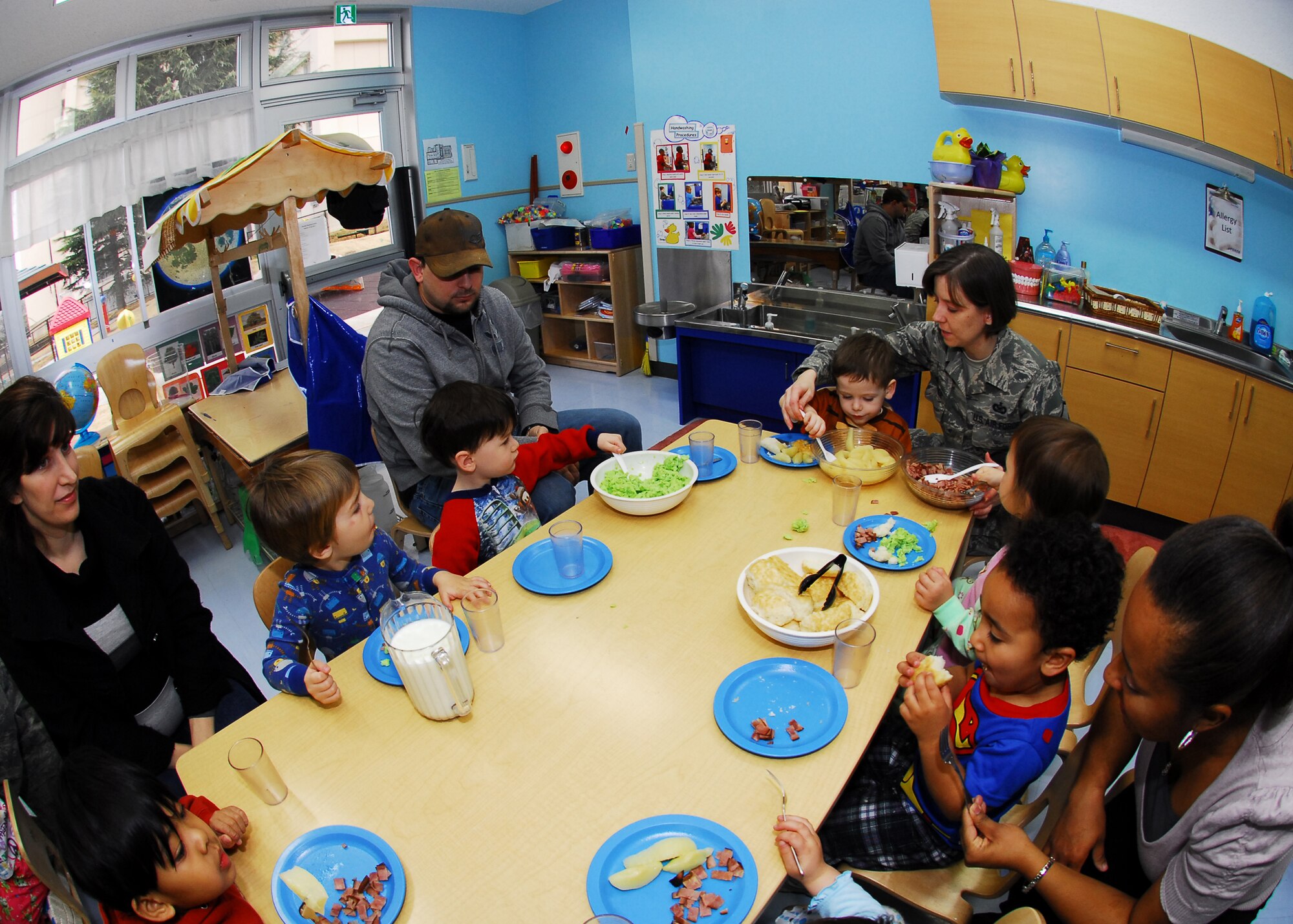 YOKOTA AIR BASE, Japan -- Parents and children at the Yume Child Development Center eat a Dr. Seuss-inspired breakfast here March 2. Both CDCs celebrated Dr. Seuss Day with green eggs and ham for breakfast and read a few books from the collection to the children. (U.S. Air Force photo/Airman 1st Class Andrea Salazar)