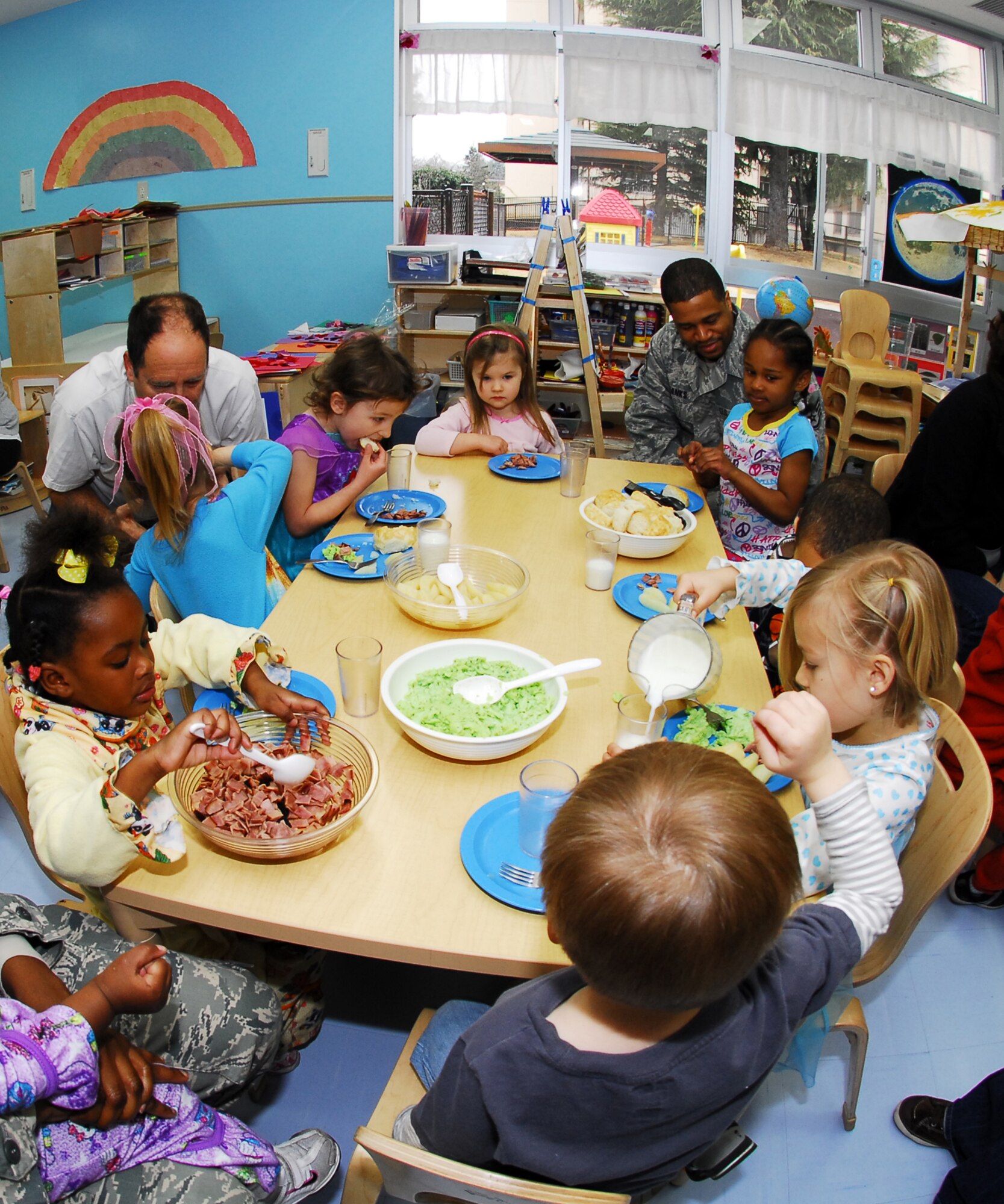 YOKOTA AIR BASE, Japan -- Children and parents at the Yume Child Development Center here enjoy green eggs and ham for breakfast March 2. Parents were invited to eat breakfast with their children as part of a celebration for the National Education Association's "Read Across America" program. (U.S. Air Force photo/Airman 1st Class Andrea Salazar)