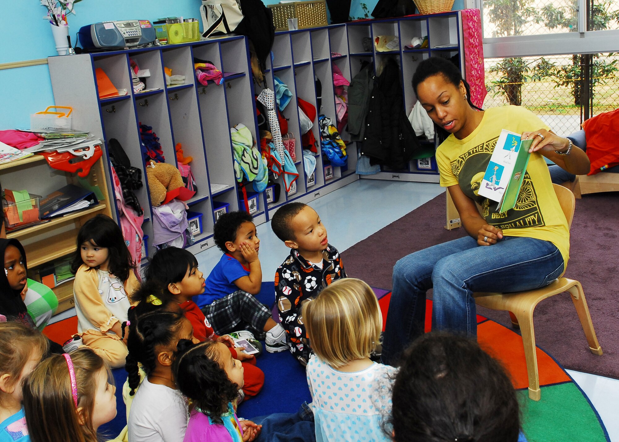 YOKOTA AIR BASE, Japan -- Crushunda Johnson, Child Development Center volunteer, reads "The Foot Book" by Dr. Seuss to a group of pre-school children during the Dr. Seuss Day here March 2. Both the Yume and Kibo CDCs celebrated Dr. Seuss Day as part of the National Education Association's "Read Across America" program. (U.S. Air Force photo/Airman 1st Class Andrea Salazar)