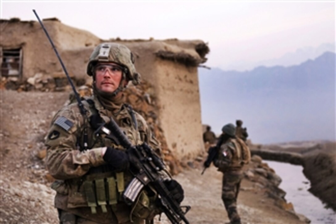 U.S. Army Sgt. Robert Streeter scans a nearby hilltop during a search of the Qual-e Jala village, Parwan province, Afghanistan, on Feb. 21, 2011.  Streeter is assigned to the 34th Infantry Division's 2nd Brigade Combat Team, 1st Squadron, 113th Cavalry Regiment, Task Force Redhorse.  