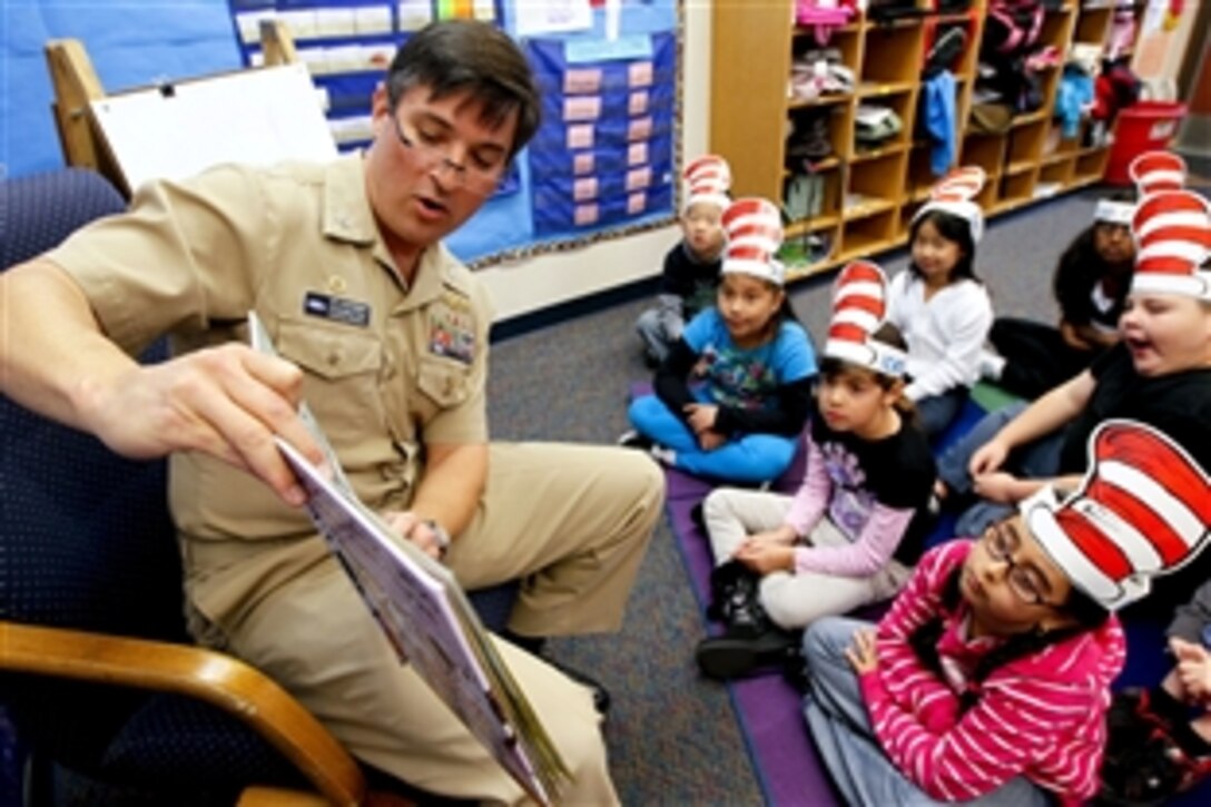 Navy Capt. Jay Kadowaki reads "Click Clack Moo: Cows That Type" to students at Clara Barton Elementary School during a Read Across America event in Corona, Calif., March 2, 2011.  The annual reading motivation and awareness program is celebrated on the birthday of Theodor Geisel, better known to millions as children's author Dr. Seuss. Kadowaki is the commanding officer of the Naval Surface Warfare Center, Corona Division.