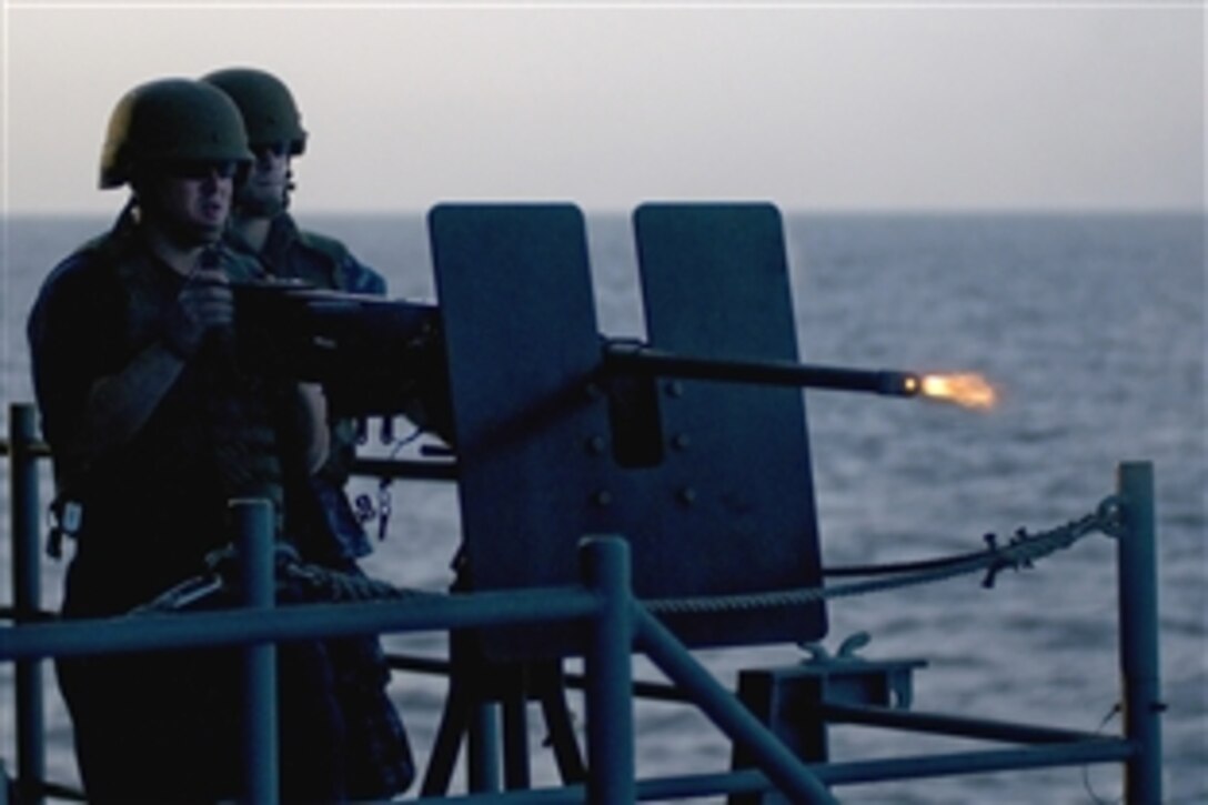 U.S. Navy Petty Officer 3rd Class Michael Padilla fires a .50-caliber machine gun during a gunnery exercise in the Arabian Sea, March 2, 2011. The Carl Vinson Carrier Strike Group is deployed supporting maritime security operations and theater security cooperation efforts in the U.S. 5th Fleet area of responsibility. Padilla, is a Aviation Ordnanceman assigned to the weapons department of the Nimitz-class aircraft carrier USS Carl Vinson.