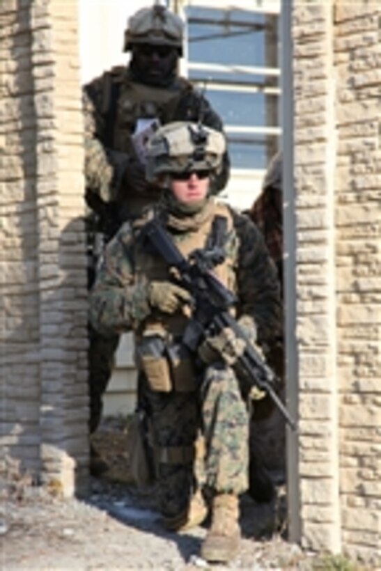 A U.S. Marine with 1st Battalion, 9th Marine Regiment, 2nd Marine Division, provides security while on patrol during a training exercise at the Mobile Military Operations on Urban Terrain Town at Camp Lejeune, N.C., on Jan. 27, 2011.  