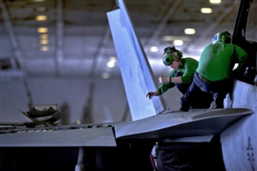 U.S. Navy Petty Officer 3rd Class Jessica Murphy, assigned to Strike Fighter Squadron 22, performs maintenance on an F/A-18F Super Hornet aircraft aboard the aircraft carrier USS Carl Vinson (CVN 70) underway in the Arabian Sea on Feb. 24, 2011.  