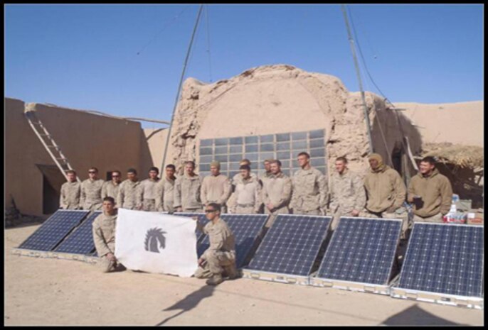 Marines and Sailors of India Company, 3rd Battalion, 5th Marine Regiment, at Patrol Base Gumbatty, Sangin District, Afghanistan, December 2010, stand with renewable energy/solar power equipment. The GREENS and SPACES systems are part of a suite of equipment from Experimental Forward Operating Base which the 3/5 has been evaluating since pre-deployment training in July.