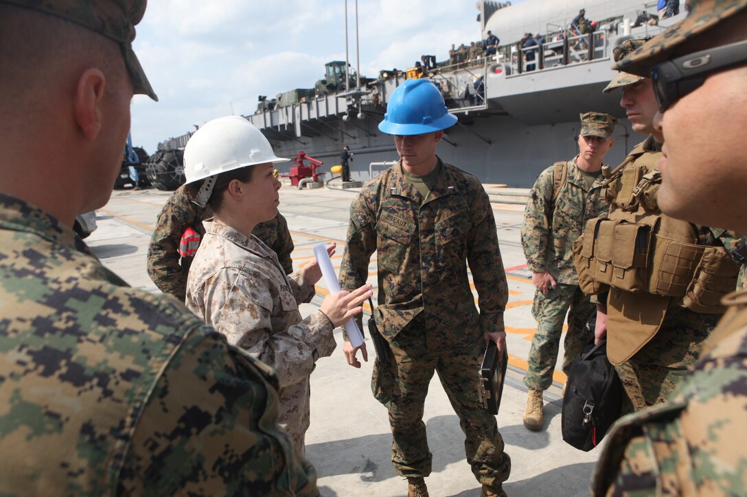 Chief Warrant Officer 2 Erin Patrick, Combat Cargo Officer, USS Harpers Ferry (LSD 49) (left), speaks with 1st Lt. Charles Breaux, team embarkation officer, 31st Marine Expeditionary Unit, regarding the movement of personnel and materials from the USS Denver (LPD 9) to the USS Harpers Ferry (LSD 49), March 4.  Elements of the 31st MEU switched ships mid-deployment allowing the MEU to remain ready to respond.  The transition comes midway through the MEU’s scheduled deployment to the Asia-Pacific region, enhancing theater security and conducting bilateral training with multiple nations.  The 31st MEU is the U.S.’s only continually forward-deployed MEU, and remains a force-in-readiness in the Asia-Pacific region at all times.