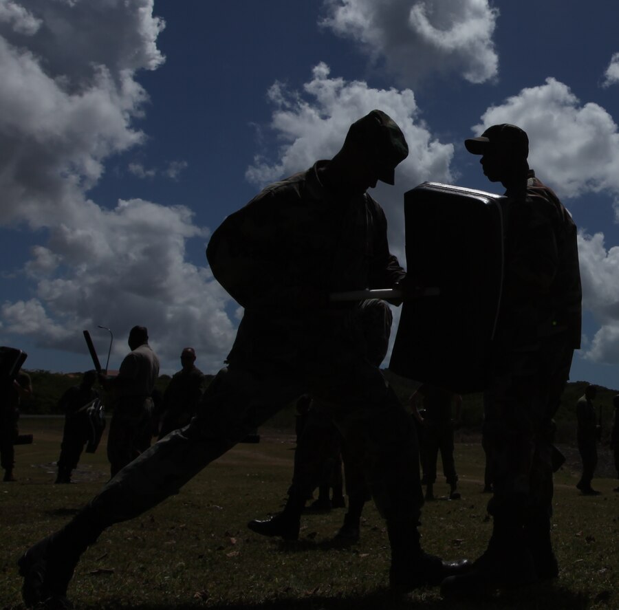 Two military policemen with the Royal Bahamas Defense Force spar with batons during non-lethal weapons training during exercise Tradewinds 2011.::r::::n::