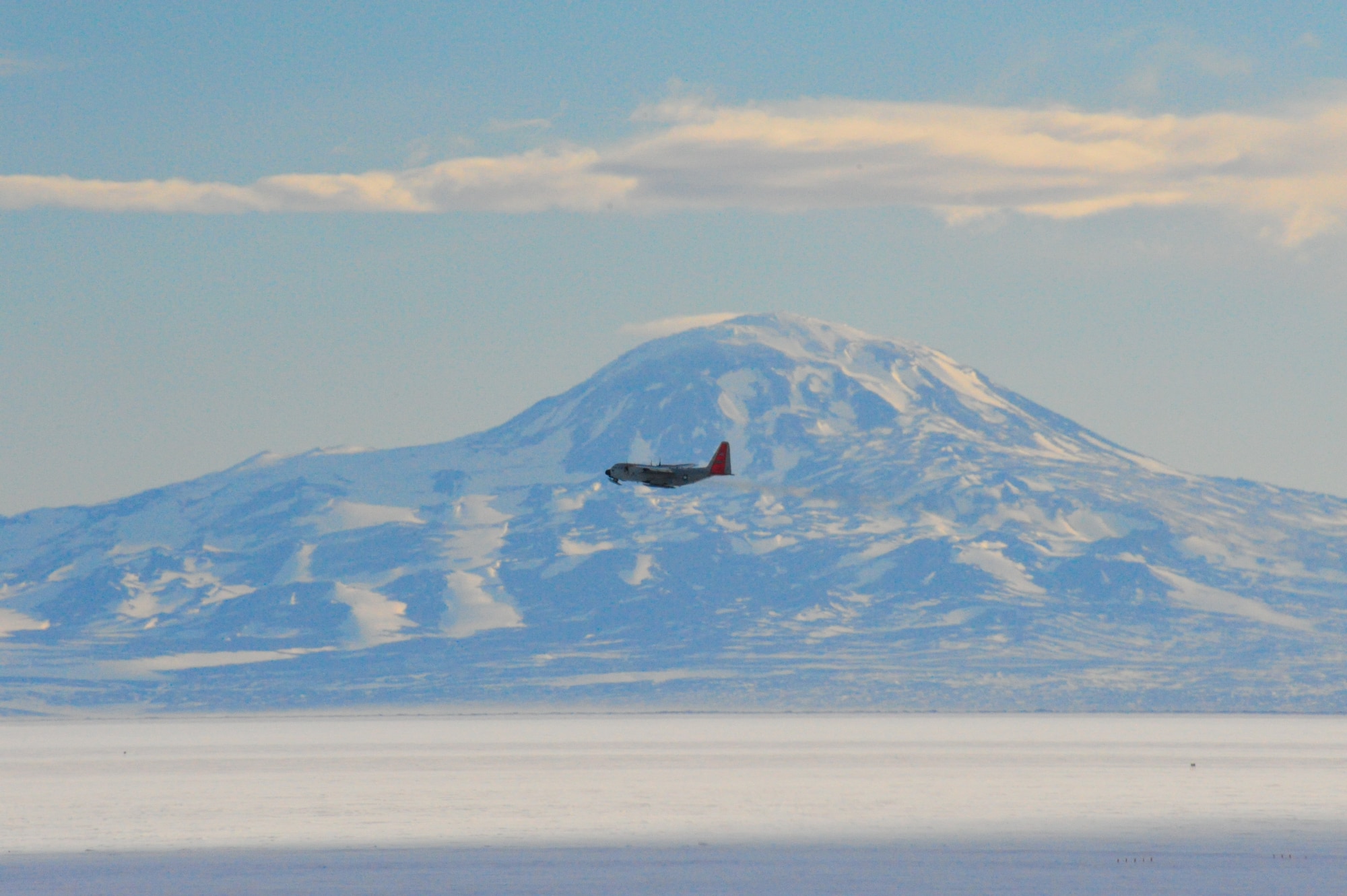 An LC-130 Ski-bird from Stratton Air National Guard Base, N.Y. flies past Mount Discovery near McMurdo Station, Antarctica, as part of Operation Deep Freeze 2010-2011. ODF is the U.S. military's operational and logistic support of the NSF's scientific research activities in Antarctica.  (U.S. Air Force photo/ Col Gary James).
