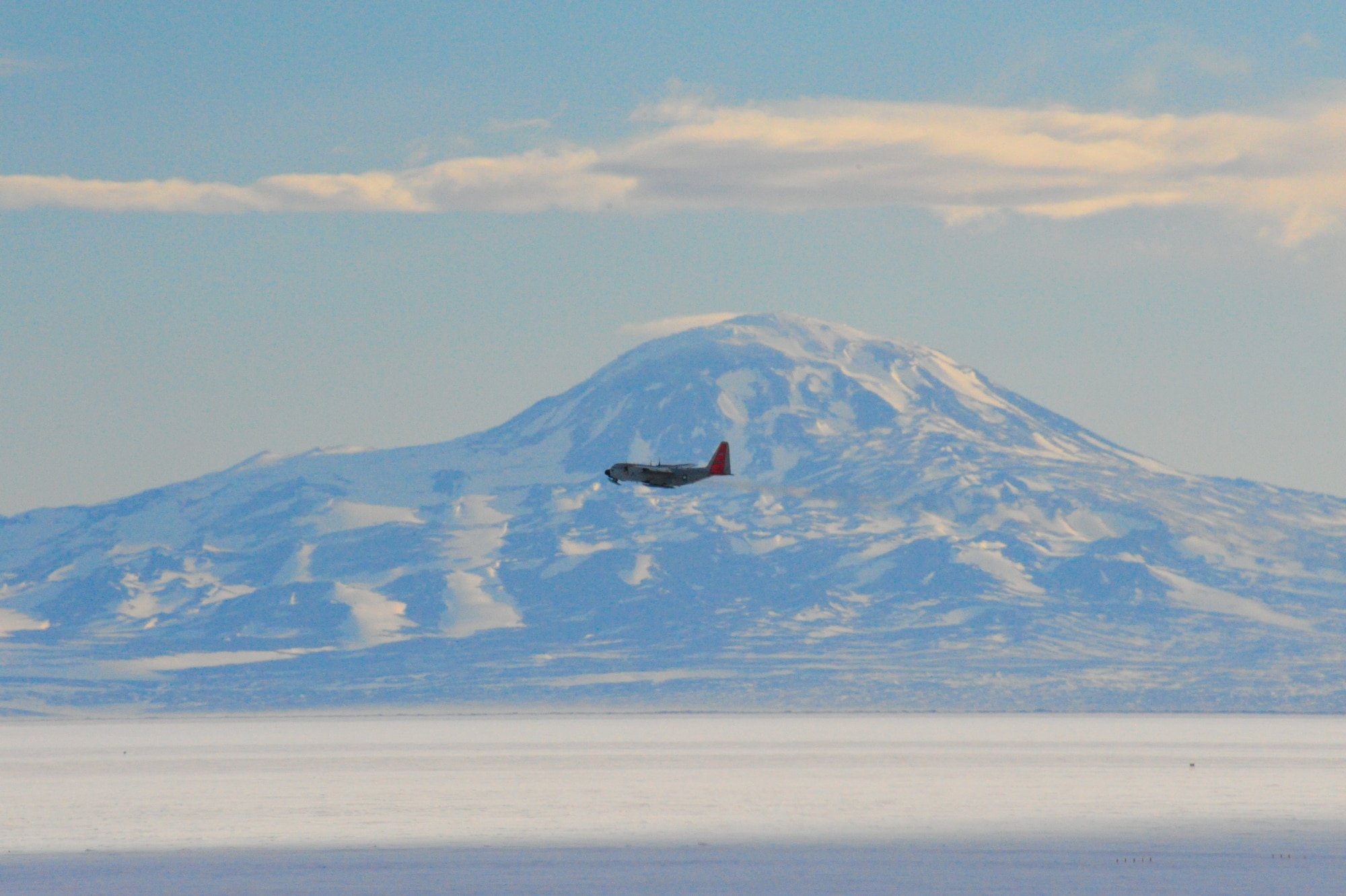 An LC-130 Ski-bird from Stratton Air National Guard Base, N.Y. flies past Mount Discovery near McMurdo Station, Antarctica, as part of Operation Deep Freeze 2010-2011. ODF is the U.S. military's operational and logistic support of the NSF's scientific research activities in Antarctica.  (U.S. Air Force photo/ Col Gary James).
