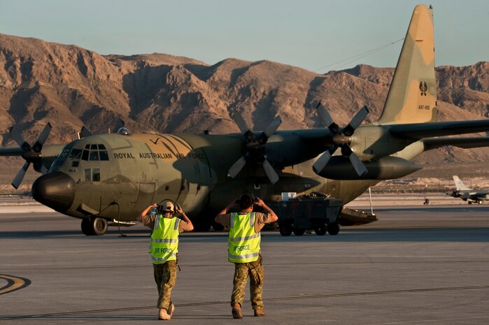 NELLIS AIR FORCE BASE, Nev. -- Royal Australian Air Force aircraft mechanics assigned to the No. 37 Squadron from Richmond, Australia put on their hearing protection as they prepare to assist in the launch of their C-130H Hercules during Red Flag 11-3, March 3. Red Flag is a realistic combat training exercise involving the air forces of the United States and its allies. The exercise takes place north of Las Vegas on the Nevada Test and Training Range--the U.S. Air Force's premier military training area with more than 12,000 square miles of airspace and 2.9 million acres of land. (U.S. Air Force photo by Tech Sgt. Michael R. Holzworth)
