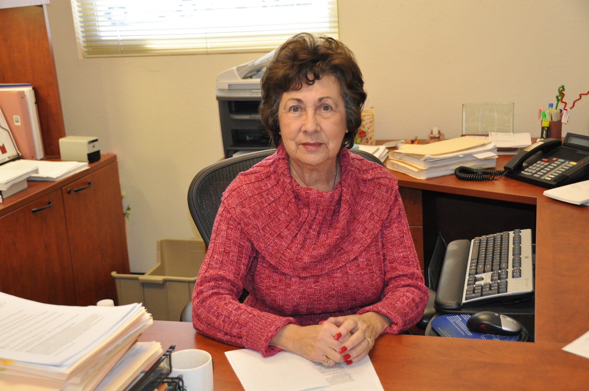 Jo Cobb, 60th Contracting Squadron contracting officer, sits thursday at her desk. Mrs. Cobb has worked for the federal goverment in various capabilities for nearly 50 years. U.S. Air Force photo/Airman 1st Class Michael Battles