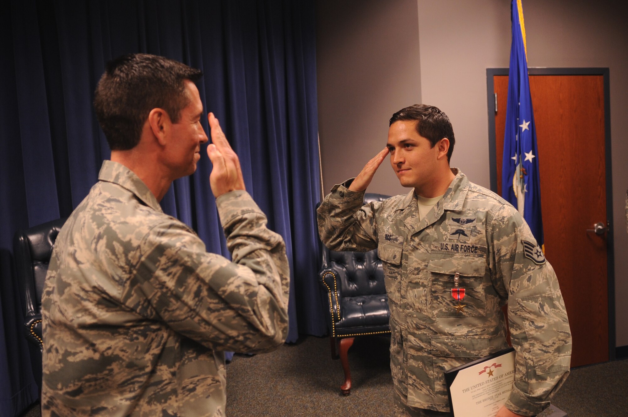 MOODY AIR FORCE, Ga. -- Staff Sgt. Andrew Rios, 38th Rescue Squadron pararescueman, salutes Lt. Col. Steven Simone, 38th RQS commander, after receiving a Bronze Star Medal with Valor during a presentation at the Senior Airman Jason D. Cunningham Airman Leadership School March 4. While deployed, Sergeant Rios volunteered to stay back with a downed plane to help secure an area while a helicopter made numerous trips to transport wounded servicemembers. (U.S. Air Force photo/Airman 1st Class Douglas Ellis)(RELEASED)
