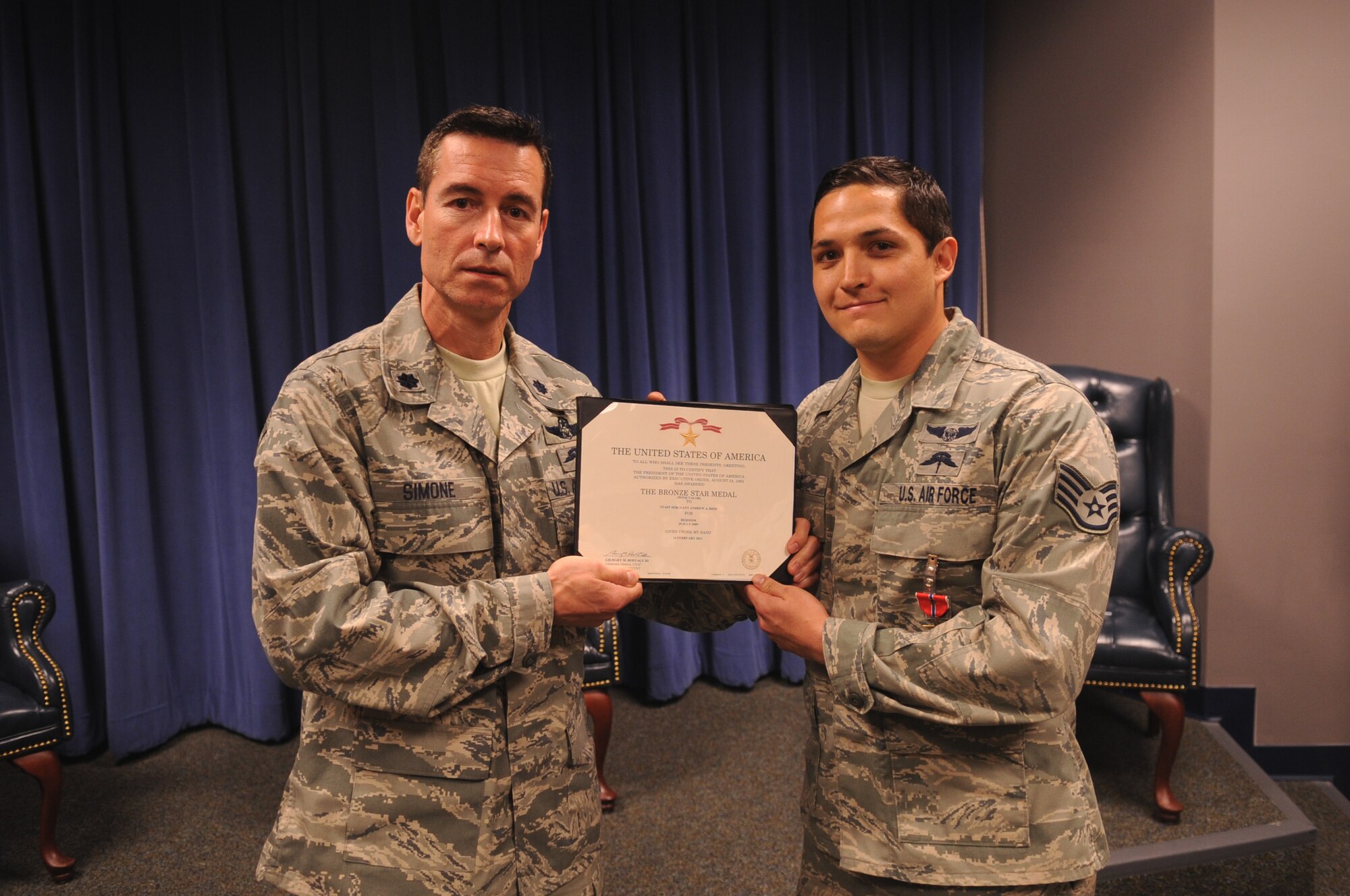 MOODY AIR FORCE, Ga. -- Staff Sgt. Andrew Rios, 38th Rescue Squadron pararescueman, is presented a Bronze Star Medal with Valor by Lt. Col. Steven Simone, 38th RQS commander, March 4. Sergeant Rios helped provide cover fire to allow aircraft to medically evacuate wounded members from a convoy that was hit by an improvised explosive device. (U.S. Air Force photo/Airman 1st Class Douglas Ellis)(RELEASED)
