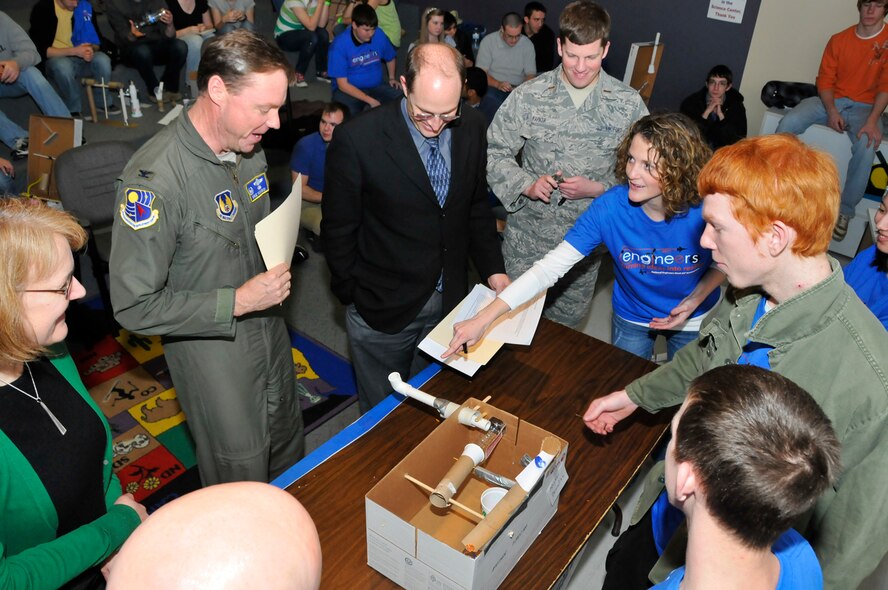 AEDC Commander Col. Michael Panarisi takes a look at one of the Rube Goldberg devices constructed during the Student Design Competition held at the Hands-On Science Center Feb. 23. Students from several area schools took part in the competition, which was one of many activities AEDC engineers were involved with as part of Engineers Week 2011.