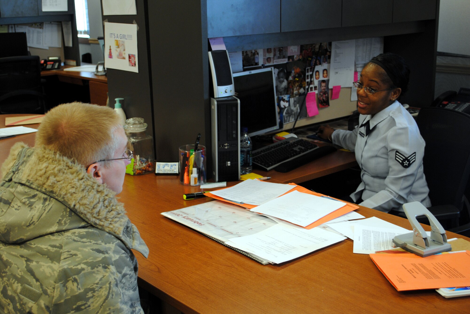Senior Airman Kay Ann Wright-Donaldson, a 341st Force Support Squadron separation and retirement personnelist, assists Senior Airman David Reynolds, a 741st Missile Security Forces Squadron member, with his separation.  Airman Wright-Donaldson acts as a liaison between the active-duty Air Force and the civilian world.  (U.S. Air Force photo/Airman Cortney Hansen)