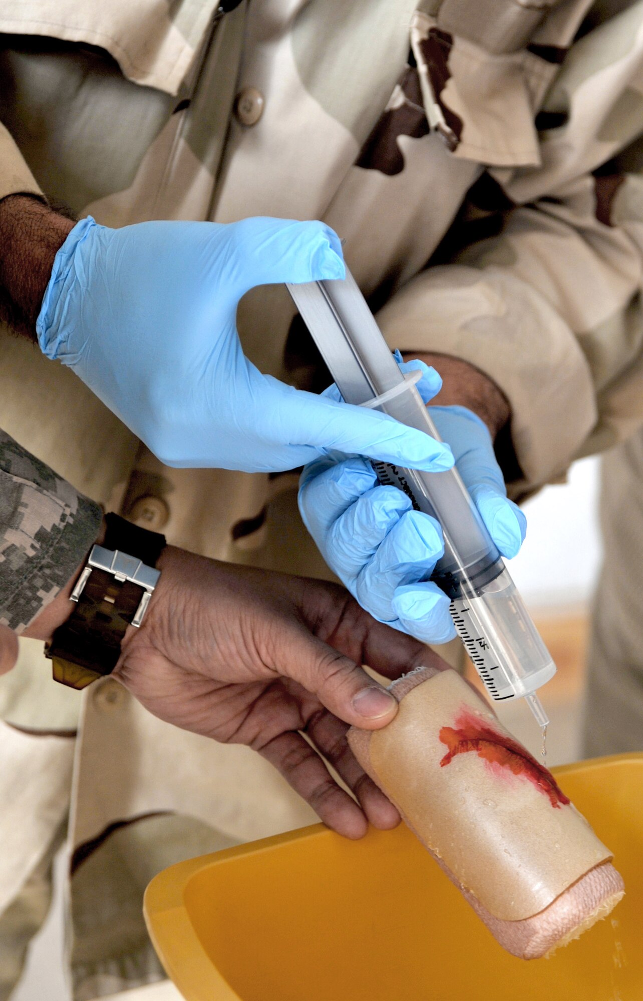 An Iraqi airman washes dirt out of an artificial laceration Feb. 23, 2011, at the medical clinic on Ali Air Base, Iraq, during a medical training course. Airmen assigned to the base transition team here have helped improve the clinic's ability to meet the needs of the Iraqi air force by providing $200,000 in essential medical equipment, increasing storage capacity and coordinating monthly self-aid buddy care training. (U.S. Air Force photo/Senior Airman Andrew Lee)
