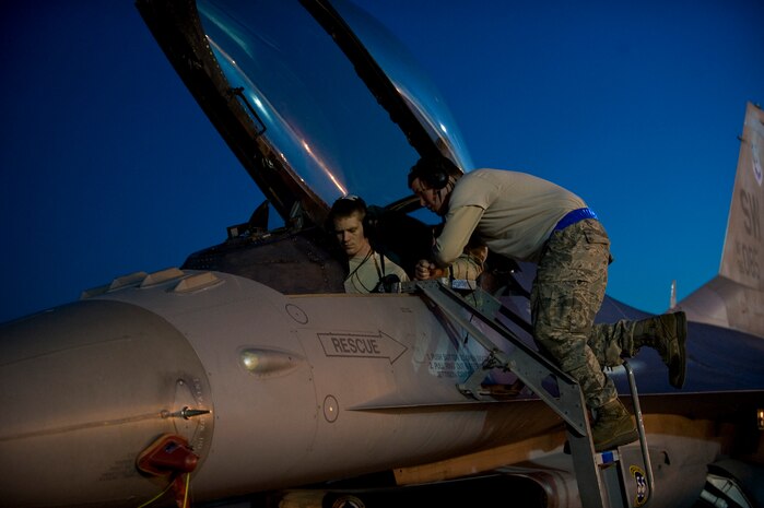 NELLIS AIR FORCE BASE, Nev. --  Senior Airman Michael Fetterly and Airman 1st Class Brian Porter, 20th Aircraft Maintenance Squadron avionics specialists, performs pre-flight maintenance on an F-16 Fighting Falcon during Red Flag 11-3, March 2.  Red Flag is a realistic combat training exercise involving the air forces of the United States and its allies. The exercise is hosted north of Las Vegas on the Nevada Test and Training Range.(U.S. Air Force photo by Airman 1st Class Matthew Lancaster)