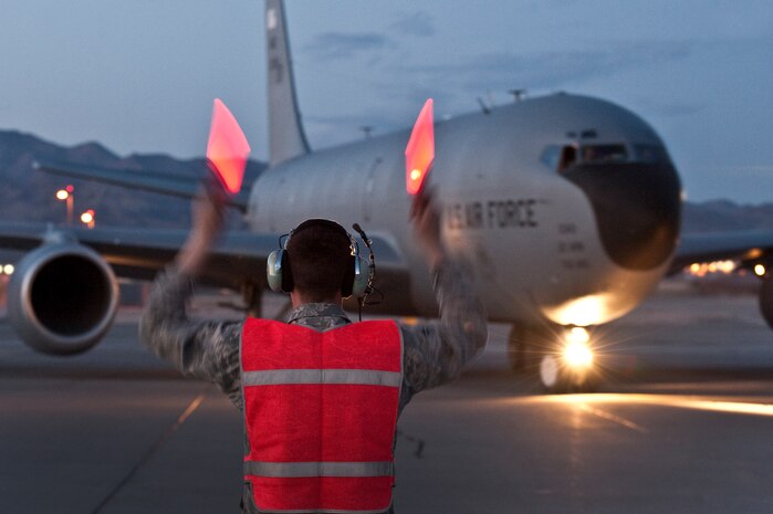 NELLIS AIR FORCE BASE, Nev. --  Airman 1st Class Arthur Smith, 22th Aircraft Maintenance Squadron crew chief, from McConnell Air Force Base, Kan.,  marshals out a  KC-135 Stratotanker for a night refueling mission during Red Flag 11-3, March 3. Red Flag is a realistic combat training exercise involving the air forces of the United States and its allies. The exercise takes place north of Las Vegas on the Nevada Test and Training Range--the U.S. Air Force's premier military training area with more than 12,000 square miles of airspace and 2.9 million acres of land. (U.S. Air Force photo by Tech Sgt. Michael R. Holzworth)