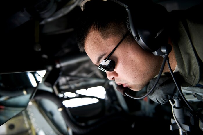NEVADA TEST AND TRAINING RANGE --  Staff Sgt. Sherwin Carino, 22th Air Refueling Wing KC-135 Stratotanker boom operator, McConnell Air Force Base, Kan., looks out the window for aircraft during Red Flag 11-3, March 3. Red Flag is a realistic combat training exercise involving the air forces of the United States and its allies. The exercise is hosted north of Las Vegas on the Nevada Test and Training Range.(U.S. Air Force photo by Senior Airman Brett Clashman)