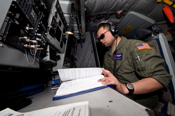NEVADA TEST AND TRAINIG RANGE --  Staff Sgt. Sherwin Carino, 22th Air Refueling Wing KC-135 Stratotanker boom operator, McConnell Air Force Base, Kan., looks over a manual operating log on a training mission during Red Flag 11-3, March 3. Red Flag is a realistic combat training exercise involving the air forces of the United States and its allies. The exercise is hosted north of Las Vegas on the Nevada Test and Training Range.(U.S. Air Force photo by Senior Airman Brett Clashman)