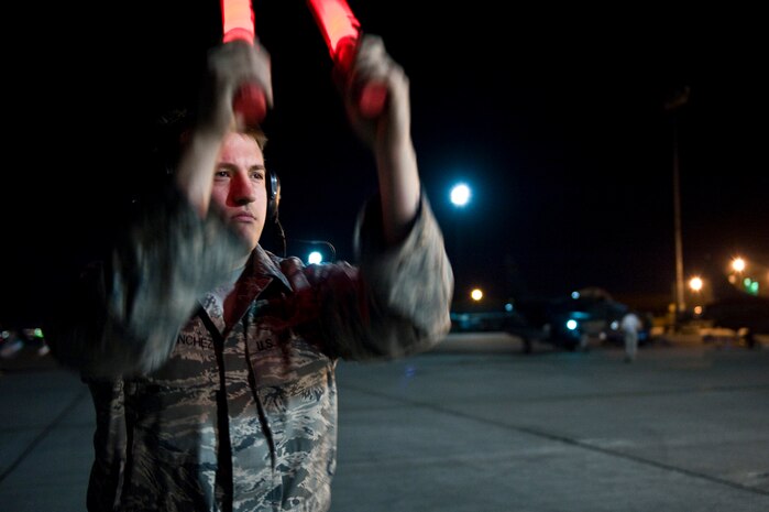 NELLIS AIR FORCE BASE, Nev. --  Airman 1st Class Jacob Sanchez, 20th Fighter Wing crew chief, Shaw Air Force Base, S.C., marshals out a F-16 Fighting Falcon for a training mission during Red Flag 11-3, March 2. Red Flag is a realistic combat training exercise involving the air forces of the United States and its allies. The exercise is hosted north of Las Vegas on the Nevada Test and Training Range.(U.S. Air Force photo by Senior Airman Brett Clashman)