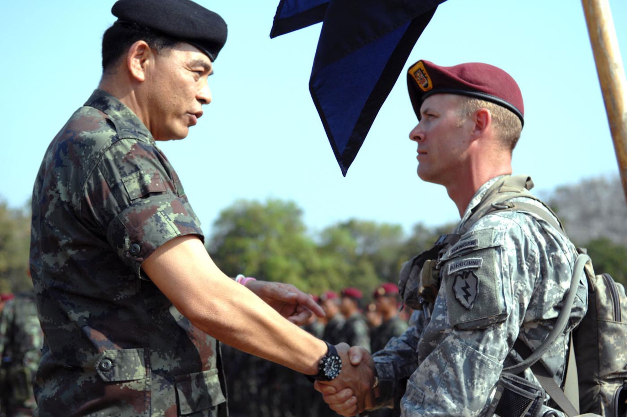 Maj. Gen. Kampanart Ruthdit, commanding general of the Royal Thai Army’s 1st Division, shakes the hand of 1st Sgt. Richard C. Wiley,
A Company, 3rd Battalion, 509th Infantry Regiment (Airborne), while inspecting Thai and U.S. troops at a Feb. 17 closing ceremony for
Exercise Cobra Gold 2011. (U.S. Army photo/Staff Sgt. Matthew E. Winstead)