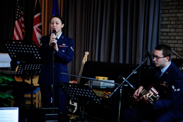 Airmen 1st Class Brianna Murph and Cameron Whitemire perform a song during the memorial service for Airman 1st Class Christoffer Johnson at the RAF Alconbury chapel March 4.  Airmen Murph and Whitemire wrote the song in memory of their friend, who died Feb. 17 while on final security patrol in Southwest Asia.  They were accompanied by Airman 1st Class Matthew Pronovost.  All four airmen are assigned to the 423rd Security Forces Squadron.  (U.S. Air Force photo/Tech. Sgt. John Barton)