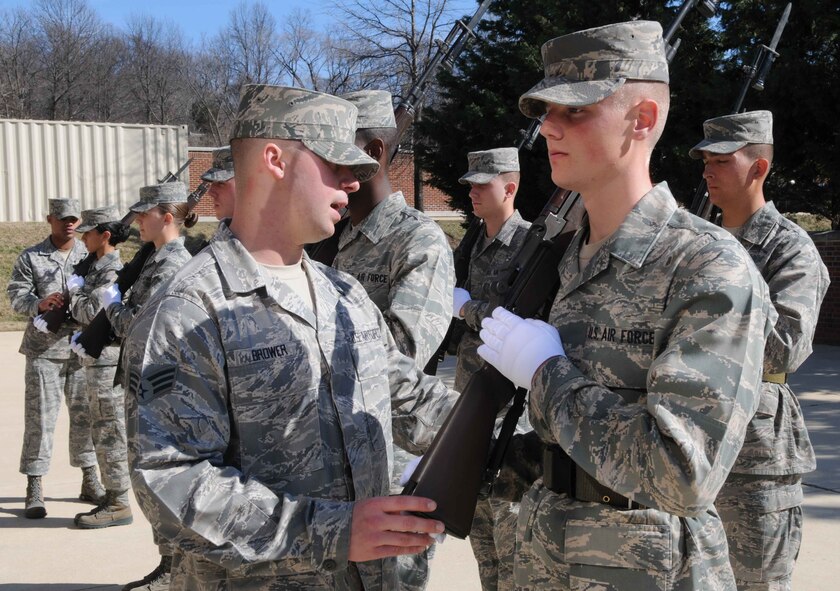 Senior Airman Leonard Brower, training course supervisor with The U.S. Air Force Honor Guard, helps adjust Airman Dylan Sullivan’s, trainee in The USAF Honor Guard technical school, rifle to the correct position Mar. 2 at Joint Base Anacostia-Bolling, Washington, D.C. Mastering the art of basic drill movements is important because it’s the foundation for everything else in the Honor Guard, said Senior Airman Leonard Brower, training course supervisor with The U.S. Air Force Honor Guard. “It’s where you start – then from that you build up to something else,” he said. (U.S. Air Force photo by Senior Airman Christopher Ruano)