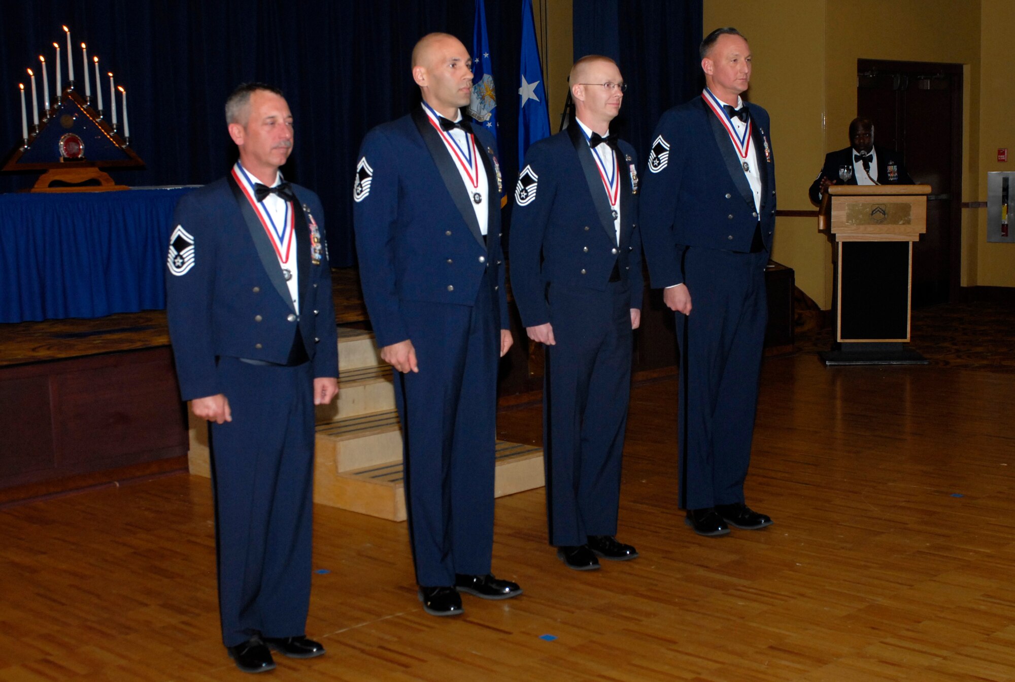 Luke Air Force Base’s newest Chief Master Sgts. John Bilczewski, 56th Component Maintenance Squadron, James Conn, 56th Maintenance Group, Stephen Kazmirski, 56th Logistics Readiness Squadron, and Gregory Schmidt, 56th Dental Squadron, stand as they’re recognized for entering the top 1 percent of the enlisted structure.   (U.S. Air Force photo/Airman 1st Class Sandra Welch)