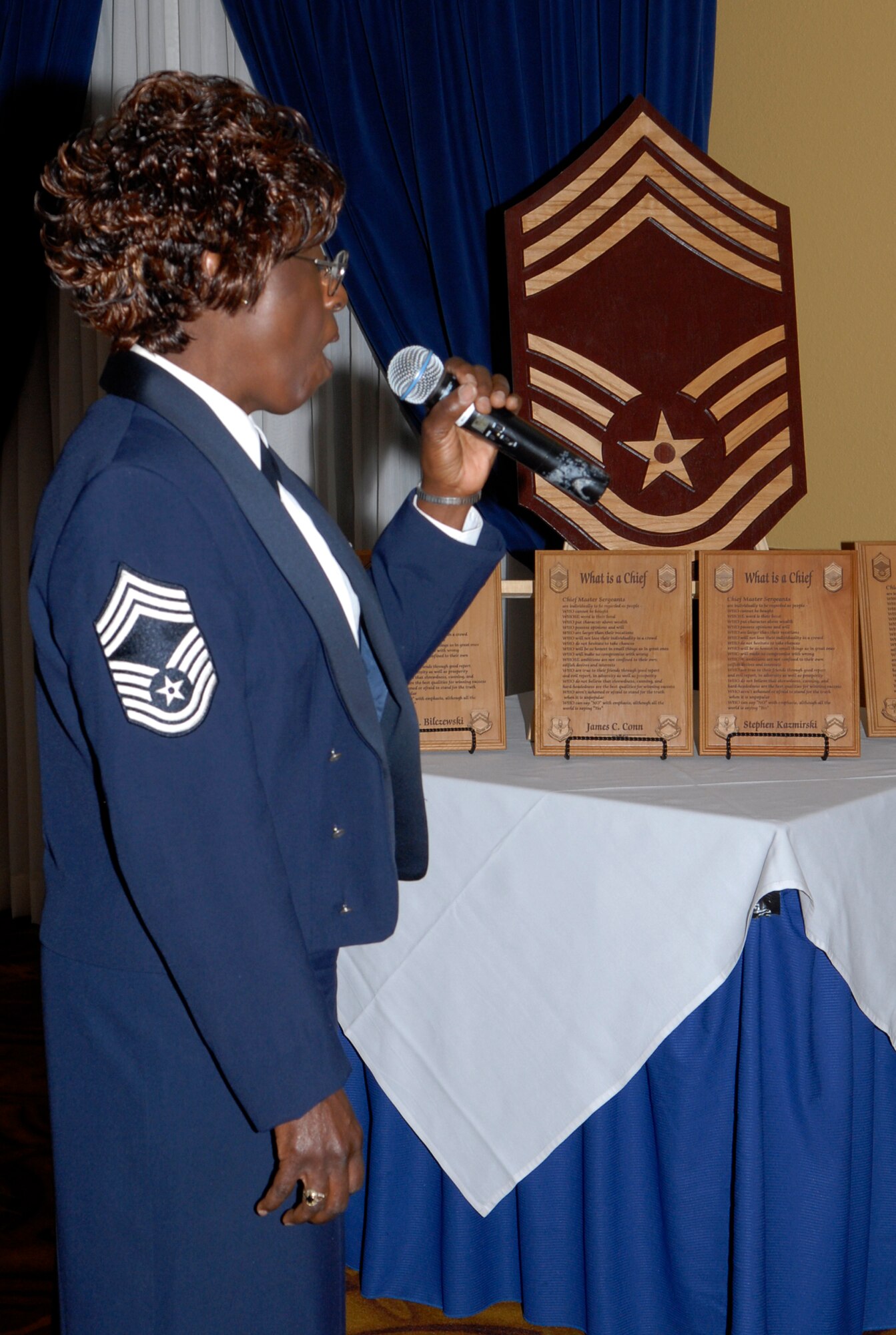 Retired Chief Master Sgt. Sandy Harris sings the National Anthem, during the Luke AFB Chief Recognition Ceremony Feb. 25th at Club Five Six. The ceremony honored four Luke Airmen for attaining the highest enlisted grade.   (U.S. Air Force photo/Airman 1st Class Sandra Welch)