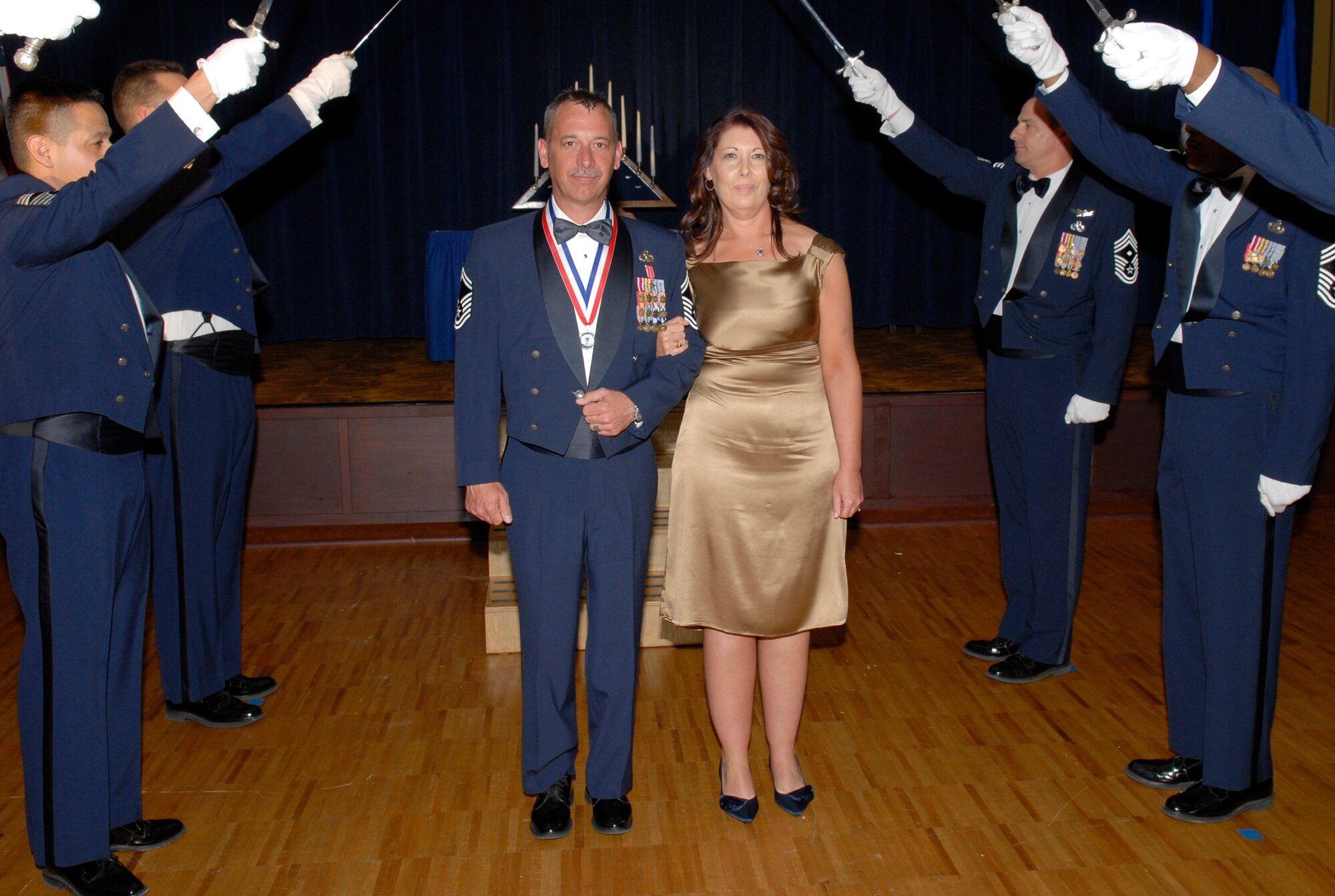 Senior Master Sgt. John Bilczewski, 56th Component Maintenance Squadron, is introduced as he walks with his wife, Cathleen, during the Chief Recognition Ceremony Feb. 25 at Club Five Six.  (U.S. Air Force photo/Airman 1st Class Sandra Welch)