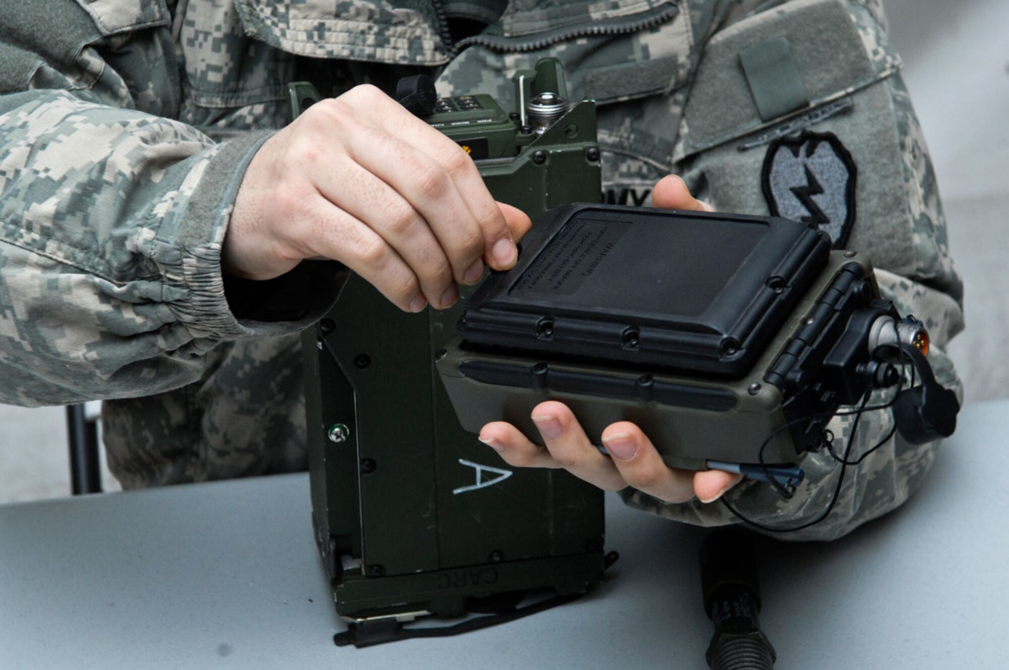 Pfc. Bahram Sorkhe puts a radio together in order to simulate delivering a salute report to higher headquarters. Sorkhe and other members of Company A, 1st Battalion, 501st Infantry Regiment (Airborne), 4th Brigade Combat Team (Airborne), 25th Infantry Division trained Feb. 22 through the 24 for their Expert Infantry Badge. (Photos by Airman 1st Class Jack Sanders/JBER PAO)(U.S. Air Force photo/Airman 1st Class Jack Sanders)