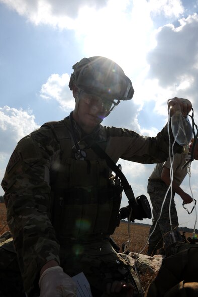 VALDOSTA, Ga.-- Senior Airman Dustin Gorski, 38th Rescue Squadron pararescueman, raises a bag of saline solution as he administers intravenous medicine to a patient during medevac training recently. During the training, the pararescuemen static line jumped from an HC-130P Combat King, landed in the drop zone, treated their patients and then carried their patients to the evacuation point. (U.S. Air Force photo/Airman 1st Class Benjamin Wiseman)(RELEASED)