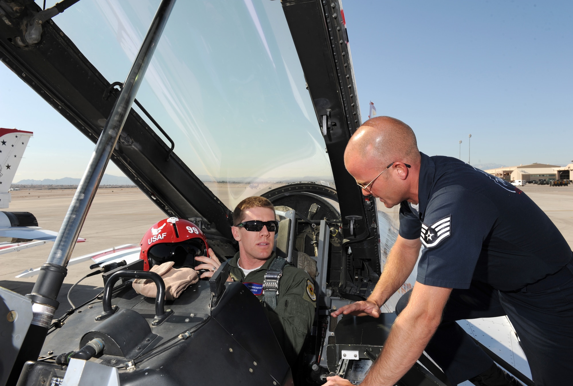 Staff Sgt. Lance Murphy, U.S. Air Force Air Demonstration Squadron "Thunderbirds" crew chief, inspects the cockpit connections for NASCAR driver Carl Edwards flight at Nellis Air Force Base, Nev., Mar. 3. Edwards, who drives the #99 car, will compete in NASCAR races March 5-6 at the Las Vegas Motor Speedway.
(U.S. Air Force Photo/Staff Sgt. Larry E. Reid Jr., Released)