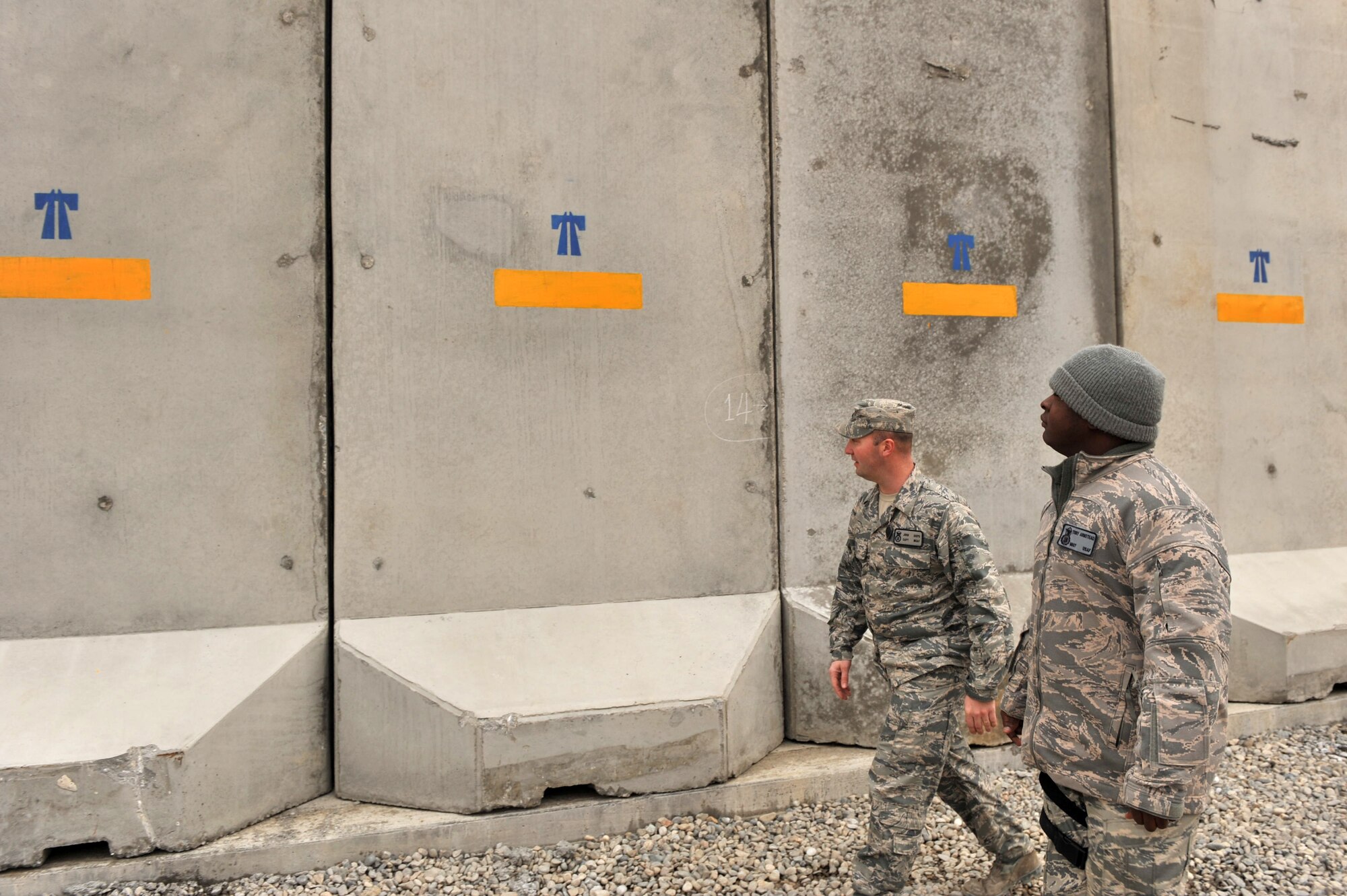 Capt. John Sieps and Master Sgt. Terry Armstead, 455th Air Expeditionary
Wing anti-terrorism office, walk the perimeter around Bagram Airfield,
Afghanistan, March 4, 2011 looking for any vulnerabilities. (U.S. Air Force
photo by Senior Airman Sheila deVera)
