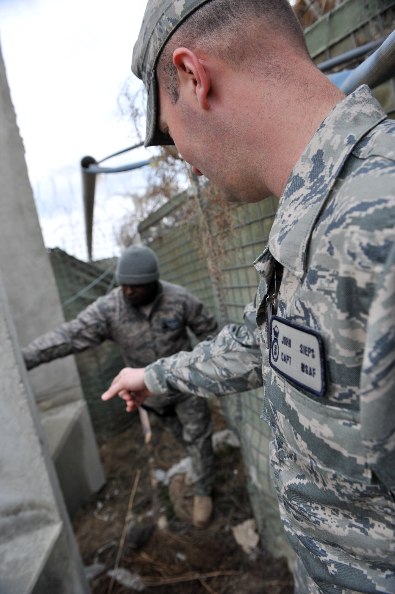 Capt. John Sieps and Master Sgt. Terry Armstead, 455th Air Expeditionary
Wing anti-terrorism office inspect a barrier at Bagram Airfield,
Afghanistan, March 4, 2011. The anti-terrorism office checks the perimeter
looking for any vulnerabilities around the base. Captain Sieps is deployed
from Andrews Air Force Base, Md., and is a native of Billings, Mont. (U.S.
Air Force photo by Senior Airman Sheila deVera)
