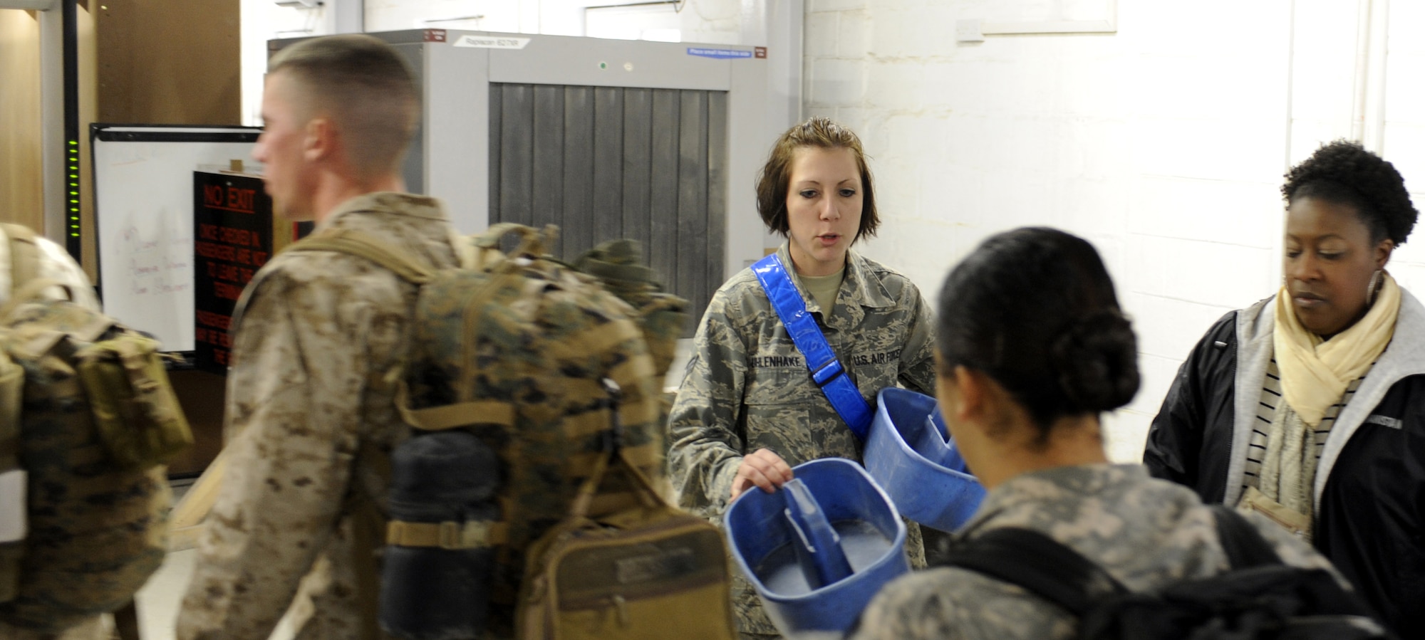 Senior Airman Sarah Uhlenhake gives directions to passengers, March 4, 2011, at Kandahar Airfield, Afghanistan. Airmen of the Aerial port at Kandahar Airfield are some of the last people deployers see before they fly home. Airman Uhlenhake is assigned to the 451st Expeditionary Logistics Readiness Squadron Aerial Port. (U.S. Air Force photo/Senior Airman Willard E. Grande II/Released) 