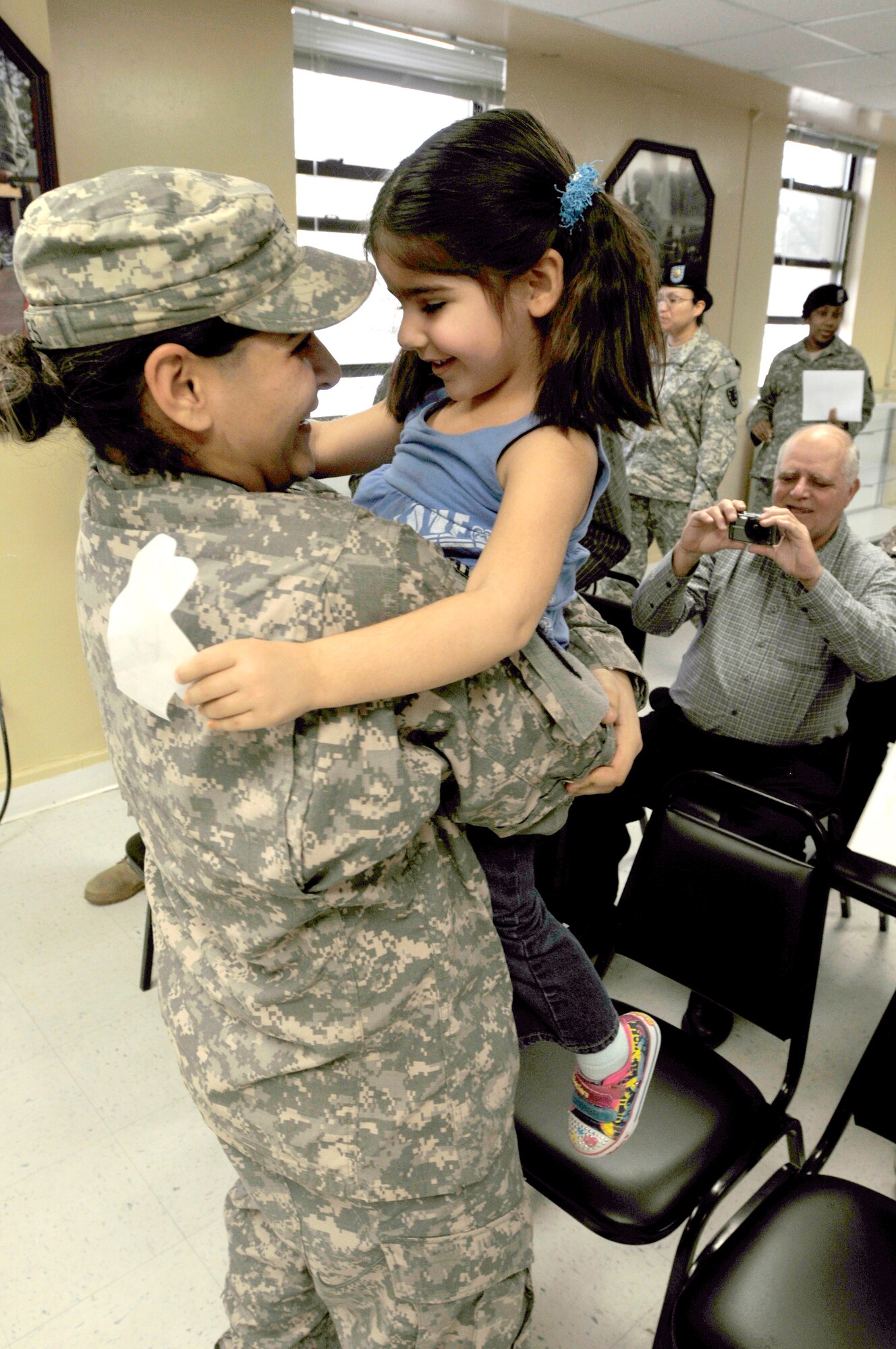 Smiles and hugs were the order of the morning Saturday for Sgt. Danielle Haynes, 510th Human Resources Company, Special Troops Battalion, 7th Sustainment Brigade, following a welcome home ceremony at the brigade’s Support Operations conference room. (Photo by Sgt. 1st Class Kelly Jo Bridgwater)


