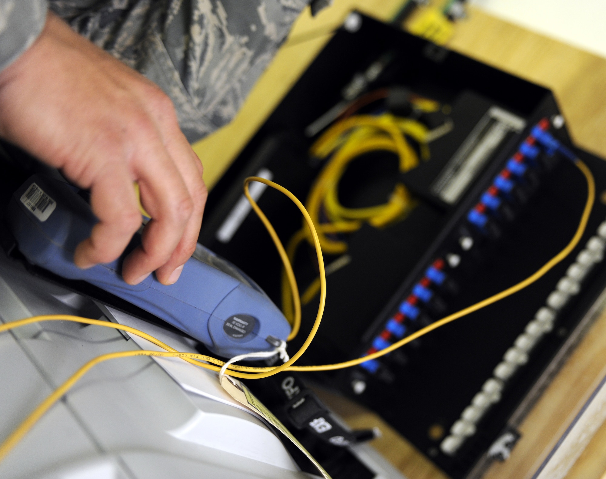 Staff Sgt. Louis Veras tests fiber optic cable with a power meter, March 2, 2011, at Kandahar Airfield, Afghanistan. Sergeant Veras will determine if the cable can be removed and the system still run efficiently. Sergeant Veras is an engineering and installation team member assigned to the 451st Expeditionary Communications Squadron. (U.S. Air Force photo/Senior Airman Willard E. Grande II/Released)