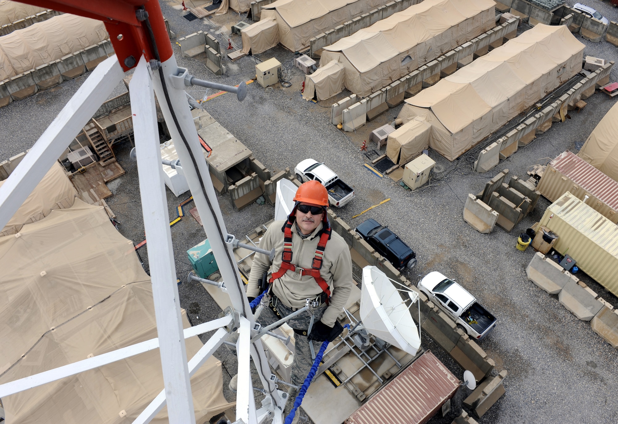 Master Sgt. Robert Rondash inspects cables on a communications tower, March 2, 2011, at Kandahar Airfield, Afghanistan. Sergeant Rondash conducts periodic visual inspections of the towers systems. Sergeant Rondash is an engineering and installation team member assigned to the 451st Expeditionary Communications Squadron. (U.S. Air Force photo/Senior Airman Willard E. Grande II/Released)