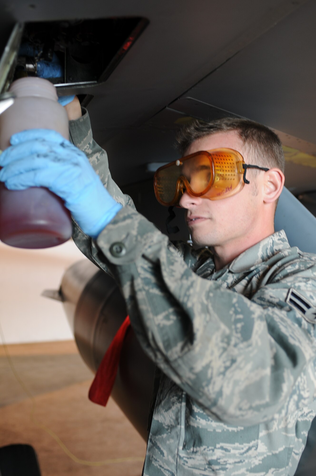 Airman 1st Class Christopher Burkhart, 31st Aircraft Maintenance Squadron F-16 Fighting Falcon crew chief, releases air from the F-16 pressure system Feb. 28. The 31st  MXS is part of the 31st Maintenance Group which is comprised of five squadrons and more than  1,400 Airmen and civilians. During fiscal year  2010 the group generated 8,295 sorties. (U.S. Air Force photo by Staff Sgt. Julius Delos Reyes)