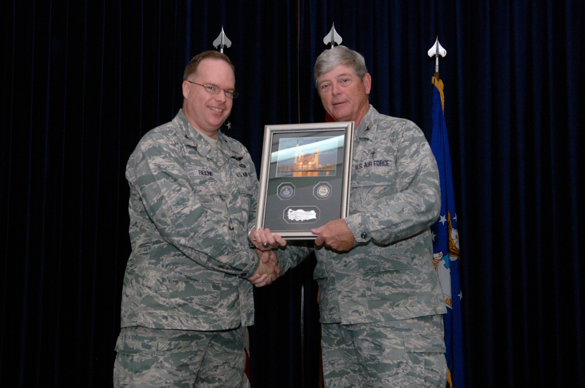 Col. Eric Beene, the 39th Air Base Wing commander, presents Col. Gerald Houge a memento from Incirlik Air Base during the National Prayer Observance breakfast held Feb. 28, 2011, at the consolidated club. Chaplain Houge was the guest speaker at the event and he shared his stories and experiences with audience.  The annual National Prayer Observance is a traditional event where the president, members of congress and other government leaders gather to reaffirm our nation’s spiritual heritage and to seek divine guidance.  (U.S. Air Force photo by Senior Airman Anthony J. Hyatt/Released)