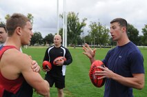 Airmen joined Sailors in gaining some knowledge about Australian Rules Football from players representing the Melboune Demons Football Club at Gosch’s Paddock in Melbourne, Australia, March 4, 2011. The Airmen are from Kadena Air Base, Japan, and Dyess Air Force Base, Texas, while the Sailors are from the  San Diego-based USS Shoup. The two groups took time out from attending the Avalon 2011 Australian International Airshow and Aerospace and Defence Exposition in Geelong, Australia. The event is one of the largest airshows in the world. The U.S. and Australian alliance spans more than 60 years and provides an opportunity for U.S and senior military officials to engage with their Australian counterparts, and ultimately contribute toward interoperability between the forces. (U.S.  Air Force photo/Master Sgt. Cohen A. Young)