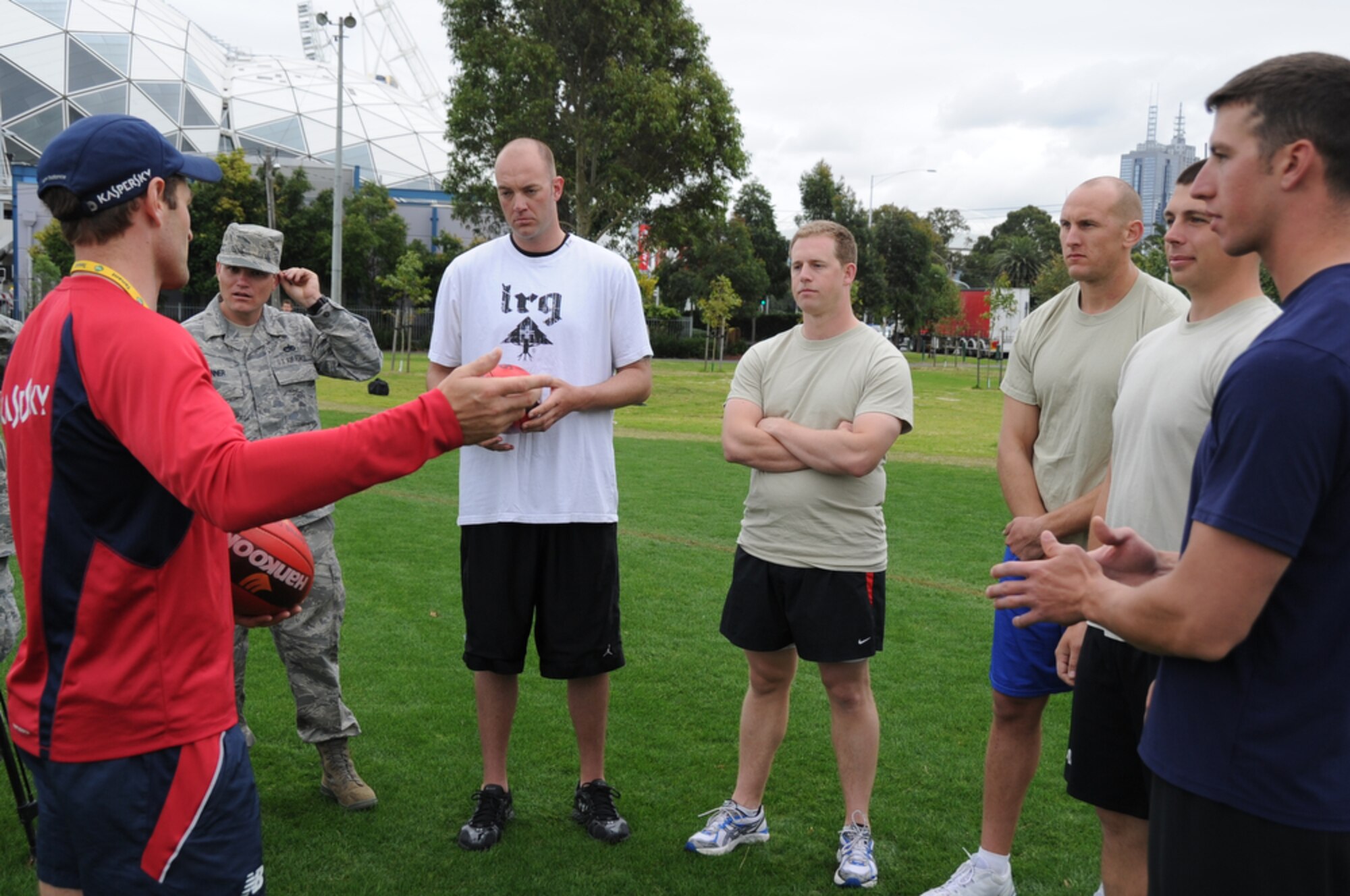 Airmen joined Sailors in gaining some knowledge about Australian Rules Football from players representing the Melboune Demons Football Club at Gosch’s Paddock in Melbourne, Australia, March 4, 2011. The Airmen are from Kadena Air Base, Japan, and Dyess Air Force Base, Texas, while the Sailors are from the  San Diego-based USS Shoup. The two groups took time out from attending the Avalon 2011 Australian International Airshow and Aerospace and Defence Exposition in Geelong, Australia. The event is one of the largest airshows in the world. The U.S. and Australian alliance spans more than 60 years and provides an opportunity for U.S and senior military officials to engage with their Australian counterparts, and ultimately contribute toward interoperability between the forces. (U.S.  Air Force photo/Master Sgt. Cohen A. Young)
