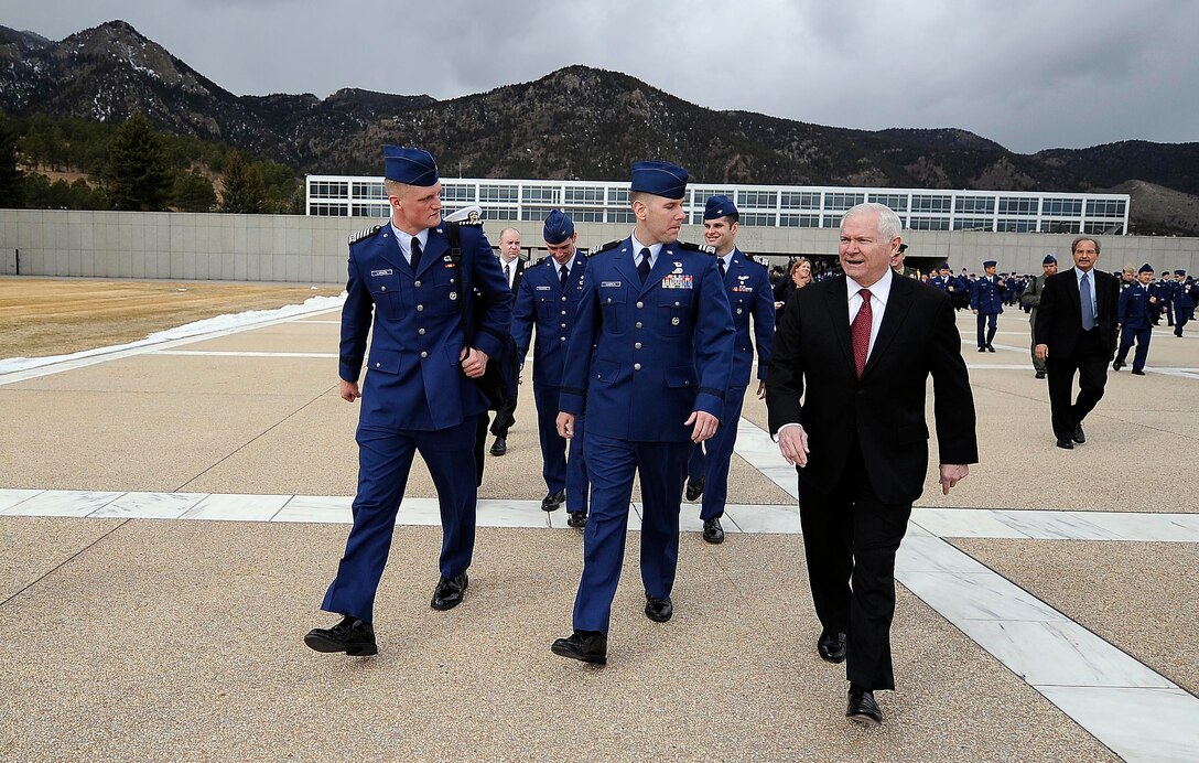 Defense Secretary Robert M. Gates walks with U.S. Air Force Academy Cadet Wing Commander Josh Larson (left) and a prior enlisted cadet prior to teaching teaching a political science and a national security class as part of the Capstone Seminar at the Air Force Academy in Colorado Springs, Colo., Mar. 4, 2011. 