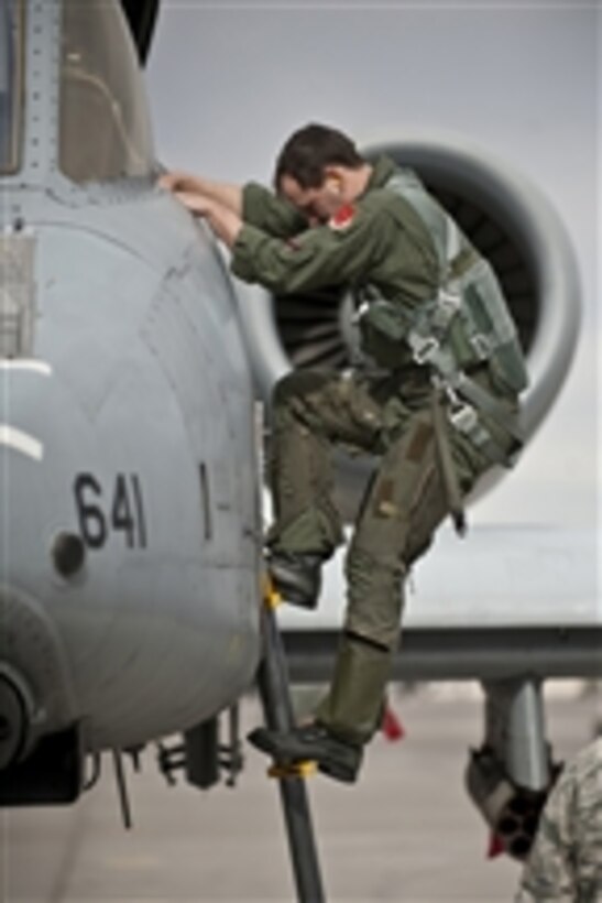 U.S. Air Force Capt. Aaron Bohn, a pilot with the 107th Fighter Squadron, climbs out of an A-10 Thunderbolt II aircraft at Nellis Air Force Base, Nev., after completing a training mission during Red Flag 11-3 on March 1, 2011.  Red Flag is a realistic combat training exercise hosted at the Nevada Test and Training Range north of Las Vegas that involves the air forces of the United States and its allies.  
